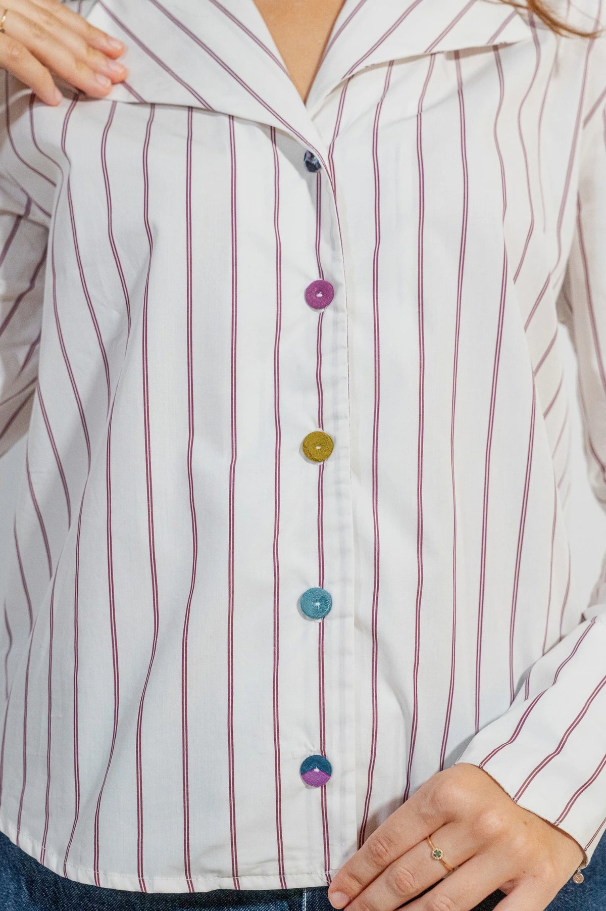 Camisa Rebeca de ATEM, blanca con rayas dobles ciruela, cuello de solapa en V y cinco botones forrados de retales.